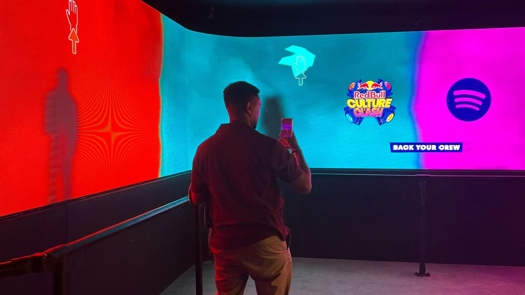 A visitor interacting with Spotify and Red Bull Culture Clash visuals at Drumsheds