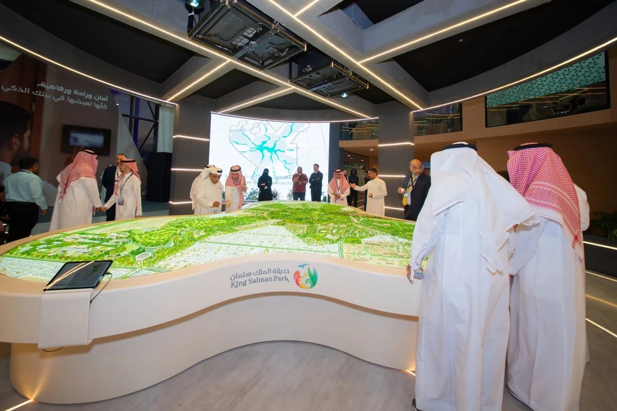 Visitors around the interactive King Salman Park presentation model at MIPIM